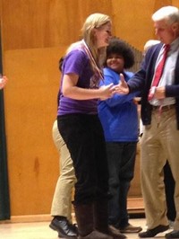 Speech and debate student receiving an award