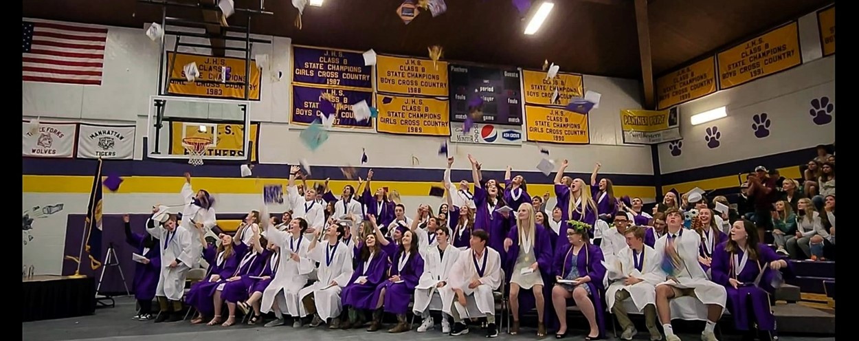 JHS 2022 graduates throwing caps in the air