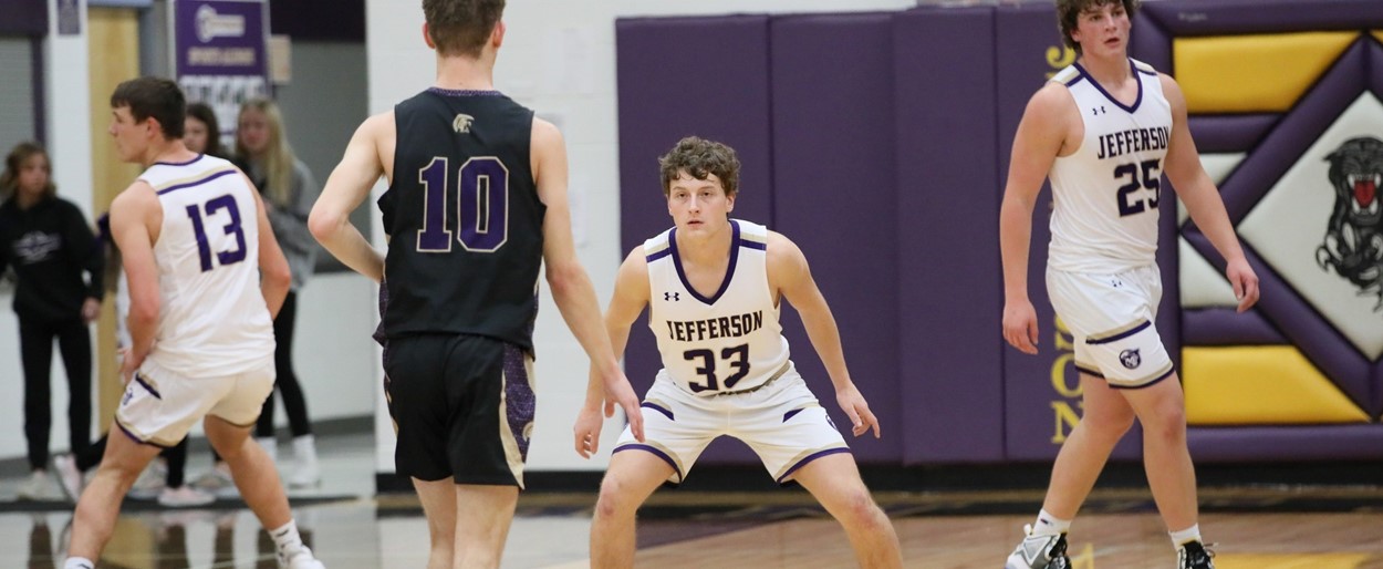 JHS boys basketball players playing defense